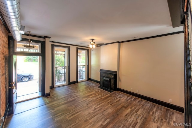 unfurnished living room with ornamental molding, dark hardwood / wood-style floors, and ceiling fan