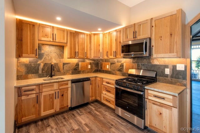 kitchen featuring appliances with stainless steel finishes, dark wood-type flooring, sink, and light brown cabinetry