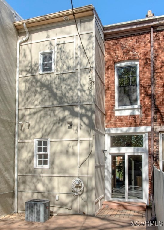 back of house featuring central AC unit