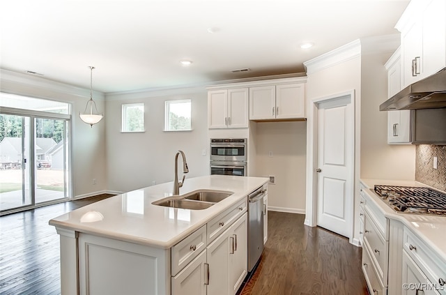 kitchen featuring stainless steel appliances, a center island with sink, sink, and a wealth of natural light