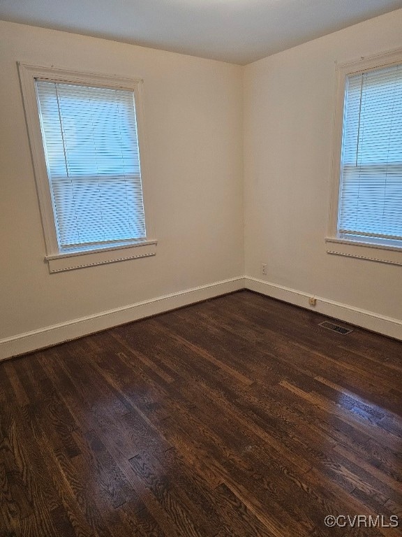 spare room with dark hardwood / wood-style floors