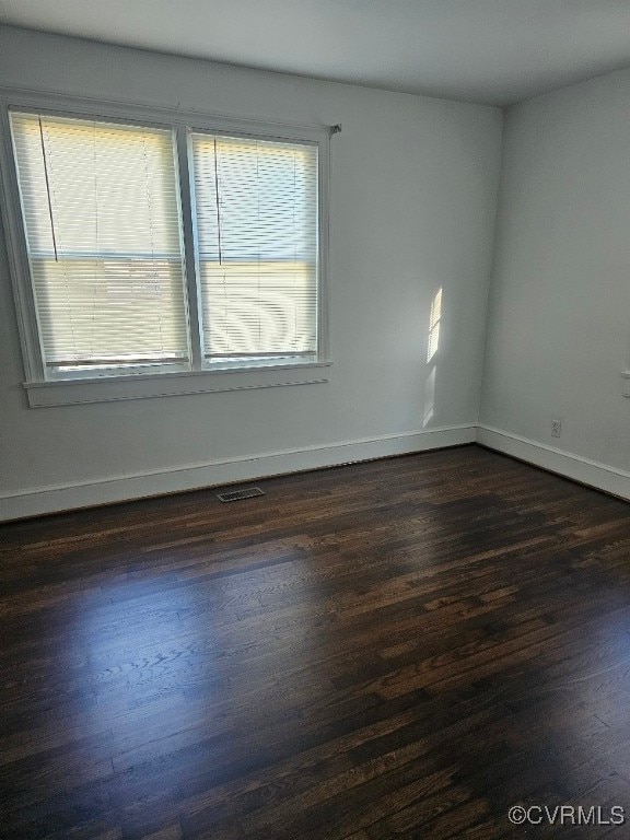 unfurnished room featuring dark hardwood / wood-style floors