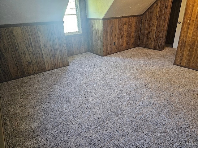 bonus room featuring wood walls