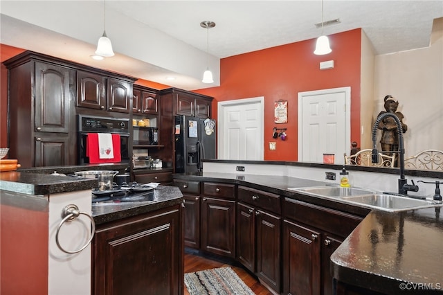 kitchen with black appliances, dark brown cabinetry, decorative light fixtures, and sink