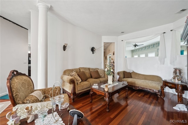 living room featuring ceiling fan, hardwood / wood-style floors, and decorative columns