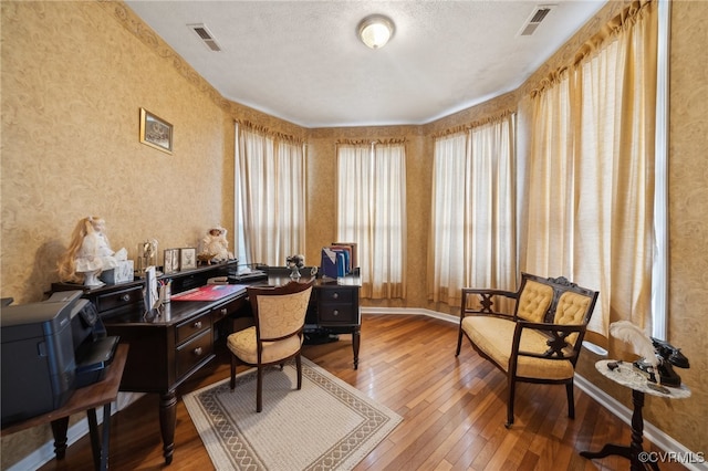 office space featuring hardwood / wood-style flooring and a textured ceiling