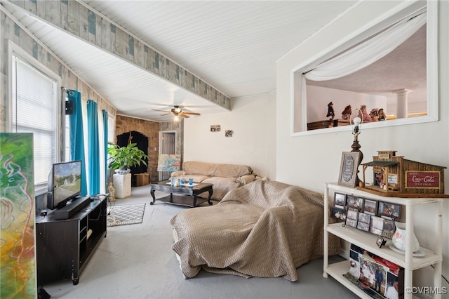 living room featuring ceiling fan and concrete floors