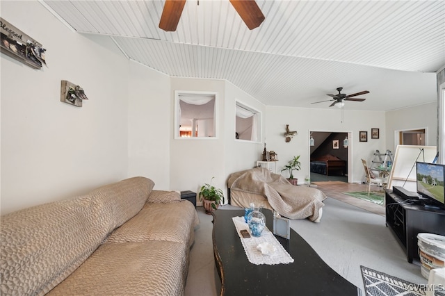 living room featuring ceiling fan and concrete floors