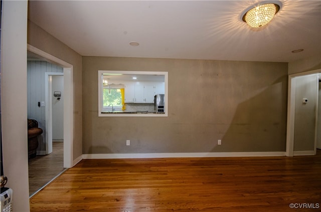 unfurnished room with hardwood / wood-style floors