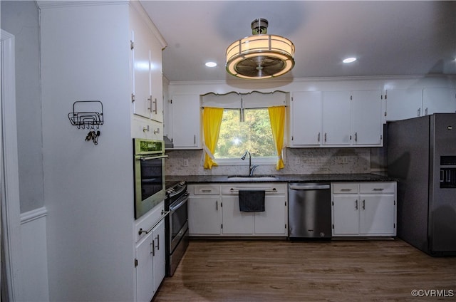 kitchen with stainless steel appliances, sink, and white cabinets