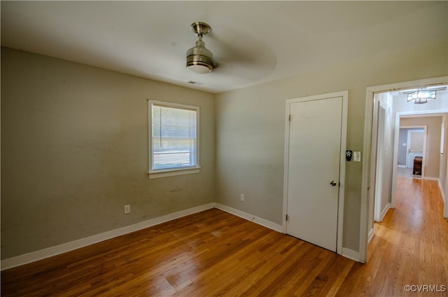 unfurnished room featuring light hardwood / wood-style flooring and ceiling fan