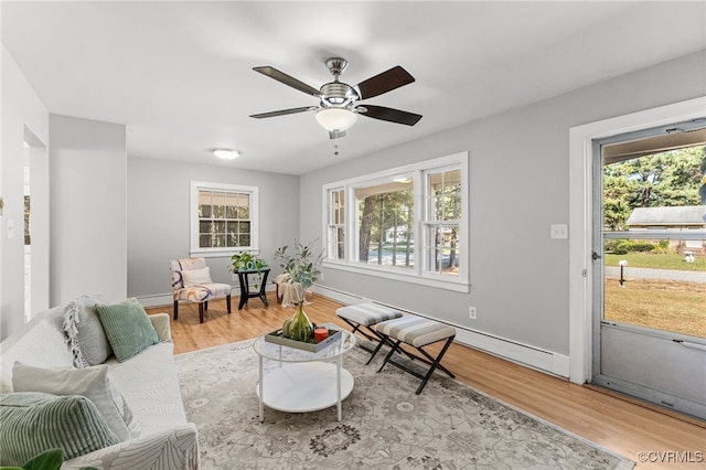 living room with light hardwood / wood-style floors, a wealth of natural light, and ceiling fan