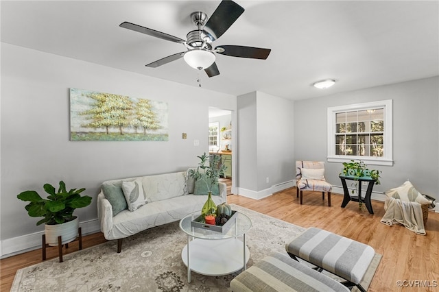 living room featuring a baseboard radiator, wood-type flooring, and ceiling fan