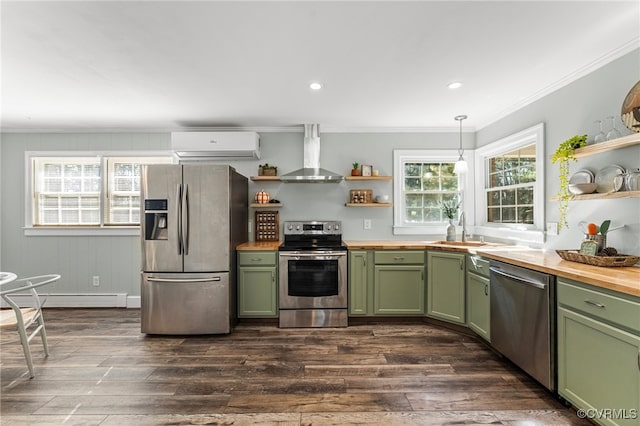 kitchen with appliances with stainless steel finishes, dark hardwood / wood-style floors, a wall mounted air conditioner, and wall chimney range hood