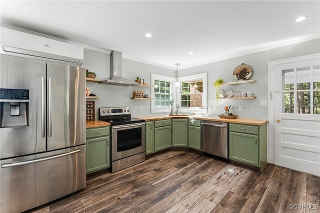 kitchen featuring butcher block counters, dark hardwood / wood-style floors, wall chimney exhaust hood, green cabinets, and appliances with stainless steel finishes