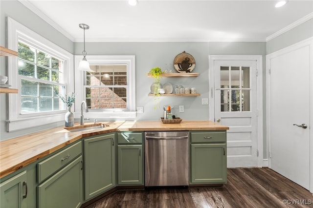 kitchen featuring hanging light fixtures, green cabinets, butcher block counters, dark wood-type flooring, and sink