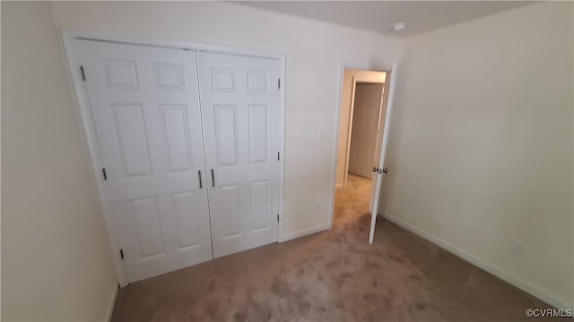 unfurnished bedroom featuring a closet and carpet