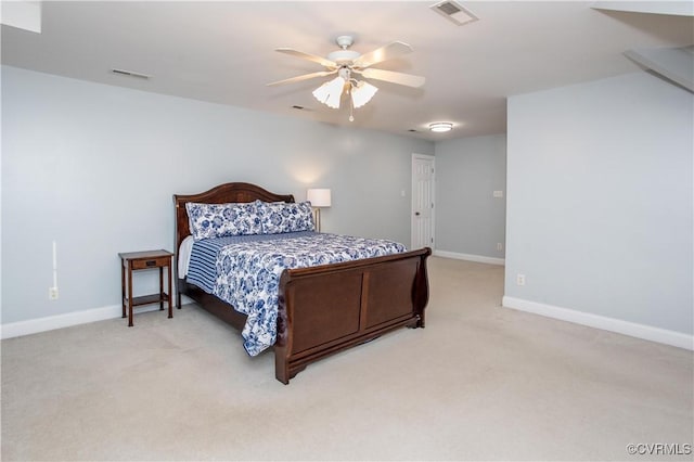 carpeted bedroom featuring baseboards, visible vents, and a ceiling fan