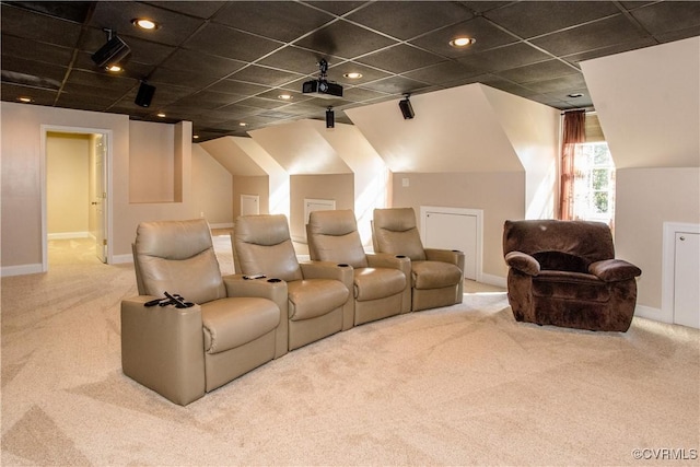 carpeted home theater room featuring a paneled ceiling and baseboards