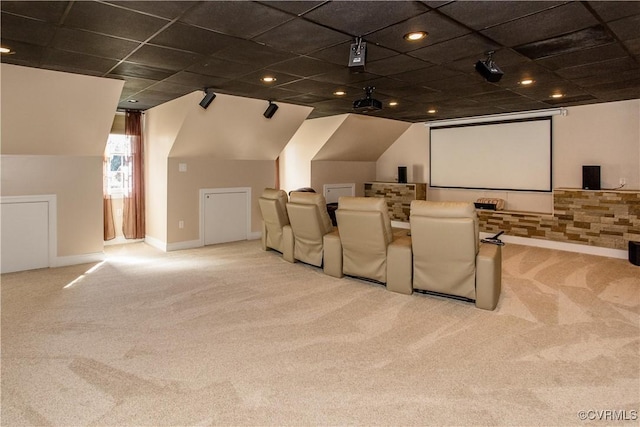 carpeted home theater featuring rail lighting and baseboards