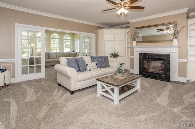 living room featuring carpet, a fireplace, and crown molding