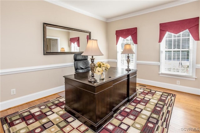 office area featuring ornamental molding, wood finished floors, a wealth of natural light, and baseboards