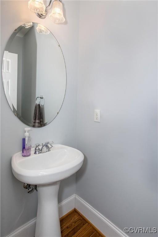 bathroom with wood finished floors and baseboards