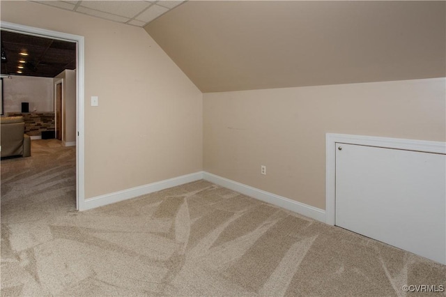 bonus room featuring baseboards, vaulted ceiling, and carpet flooring