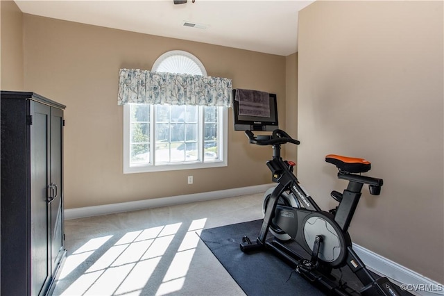 exercise area featuring light colored carpet, visible vents, and baseboards