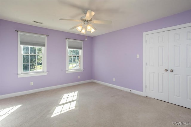 unfurnished bedroom featuring a closet, visible vents, ceiling fan, and baseboards