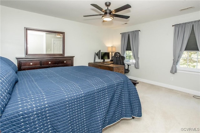 carpeted bedroom with ceiling fan, visible vents, and baseboards