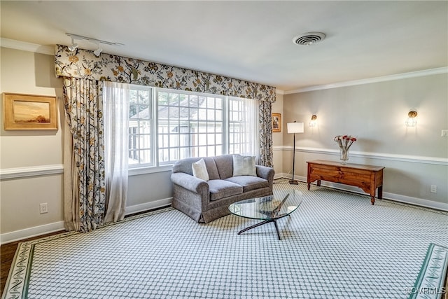 living room with crown molding and track lighting