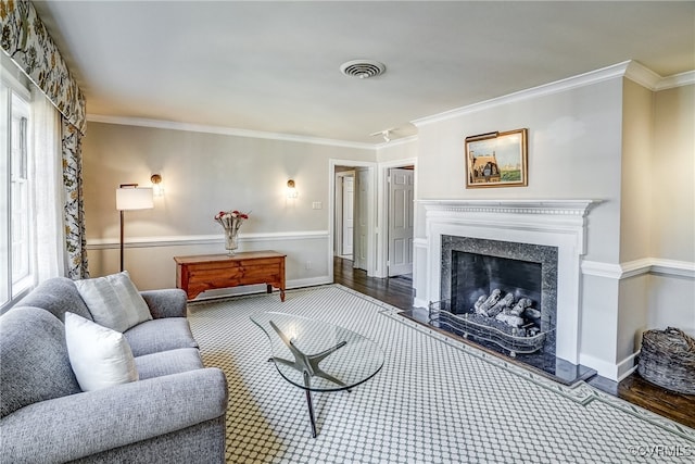 living room featuring crown molding, dark hardwood / wood-style flooring, and a high end fireplace