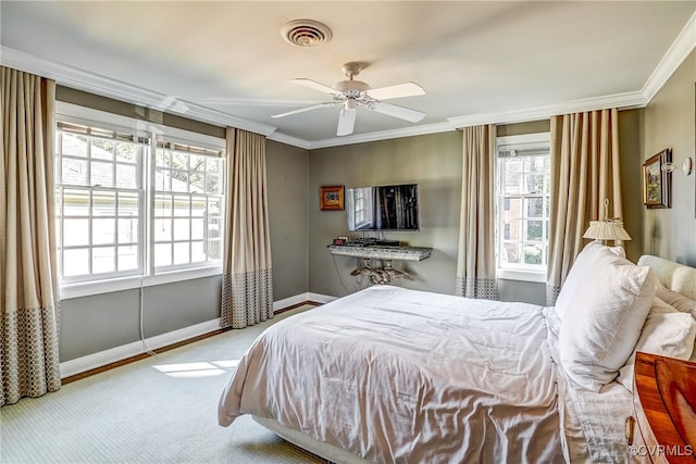 carpeted bedroom with ornamental molding, multiple windows, and ceiling fan