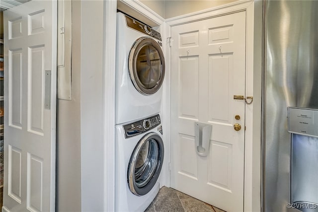 clothes washing area with stacked washer and dryer