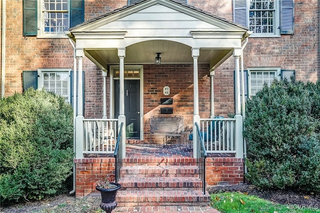 view of exterior entry featuring a porch