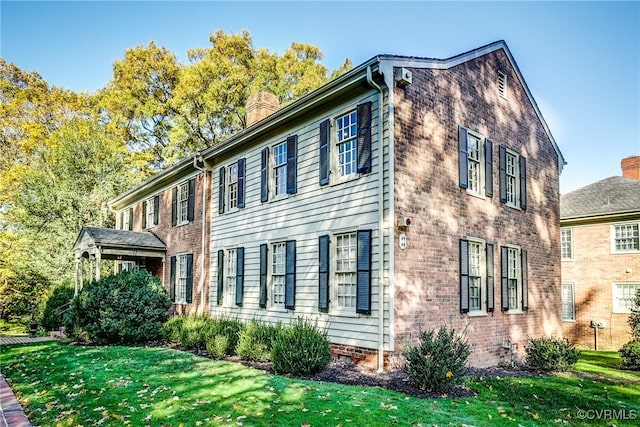 view of side of property with a lawn