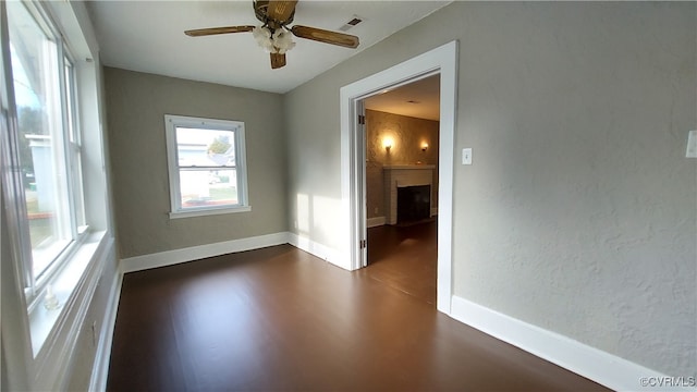 unfurnished room with hardwood / wood-style floors and ceiling fan