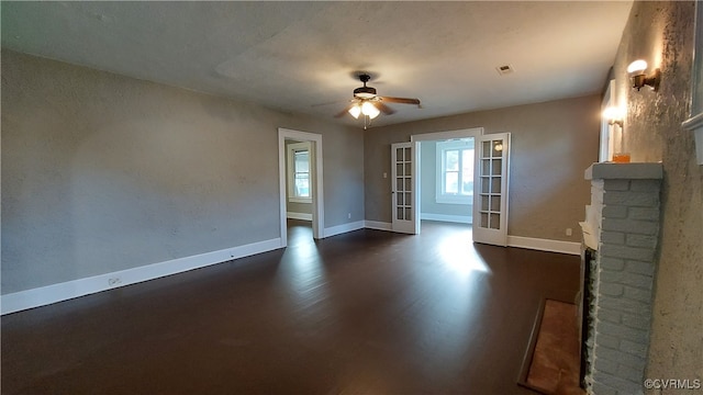 unfurnished living room with ceiling fan, french doors, and dark hardwood / wood-style floors