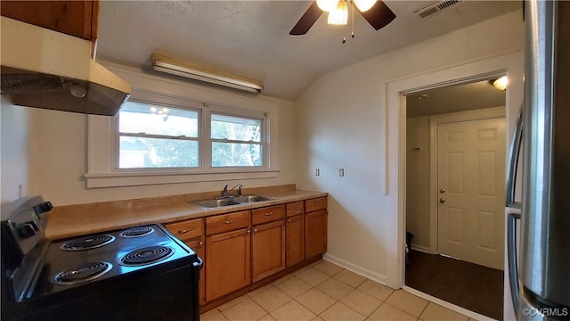 kitchen with stainless steel refrigerator, electric range, sink, ceiling fan, and light tile patterned flooring