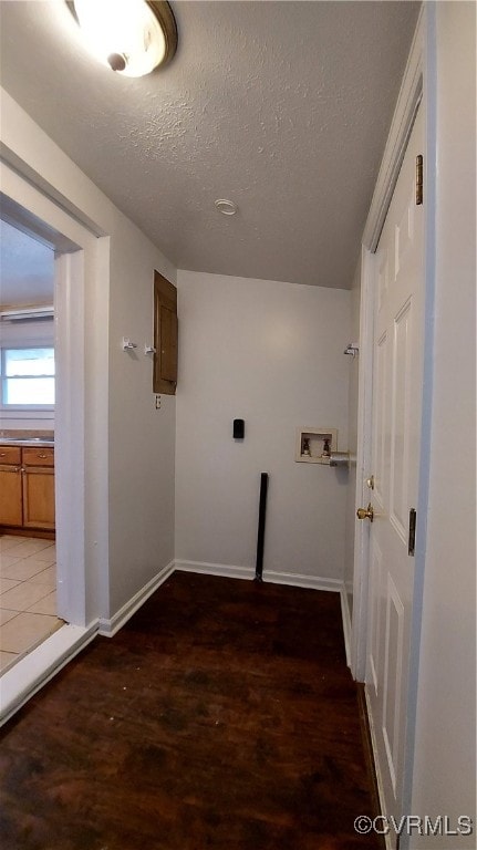 laundry room with hookup for a washing machine, dark hardwood / wood-style flooring, and a textured ceiling