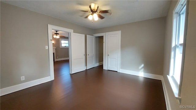 spare room with ceiling fan and dark hardwood / wood-style flooring