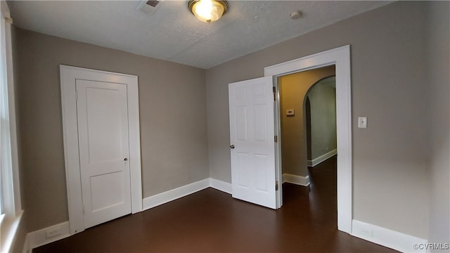 unfurnished bedroom with a textured ceiling