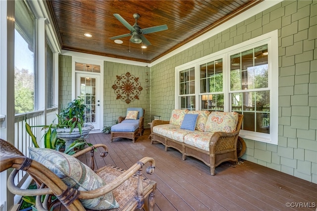 sunroom with ceiling fan and wood ceiling