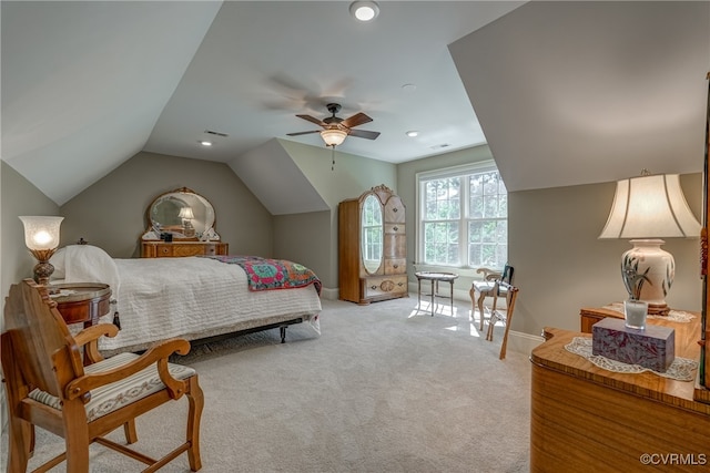 carpeted bedroom with ceiling fan and vaulted ceiling