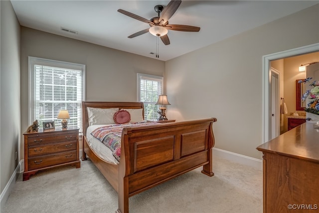 carpeted bedroom with connected bathroom and ceiling fan