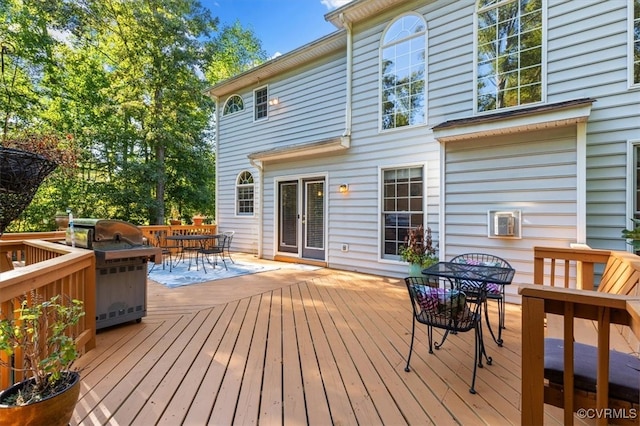 wooden terrace featuring a grill