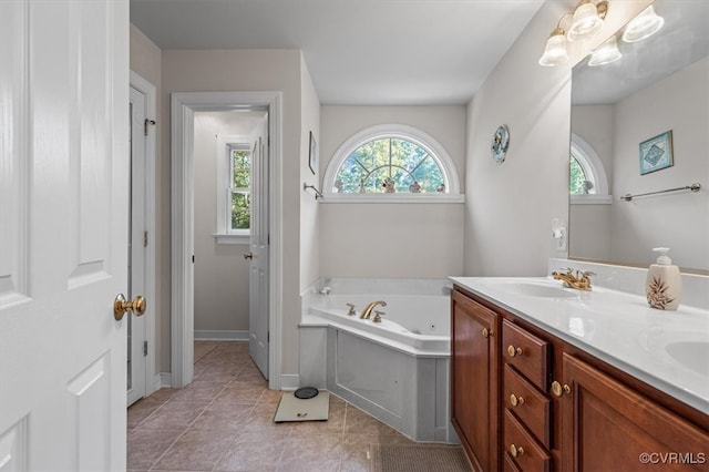 bathroom featuring a washtub, vanity, and tile patterned floors