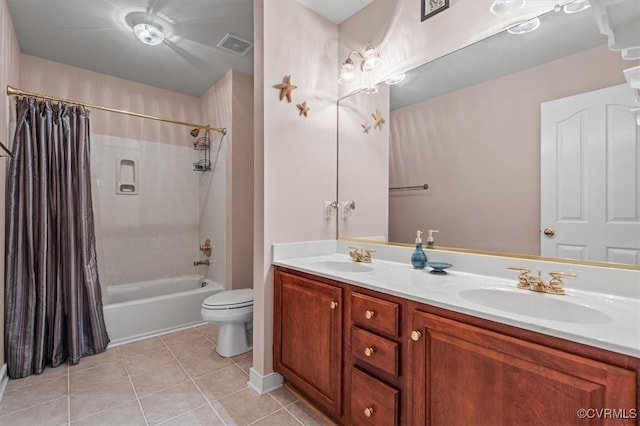 full bathroom featuring toilet, vanity, tile patterned floors, and shower / tub combo with curtain