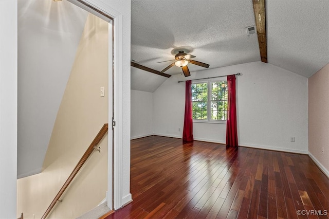 bonus room with ceiling fan, dark hardwood / wood-style flooring, lofted ceiling with beams, and a textured ceiling